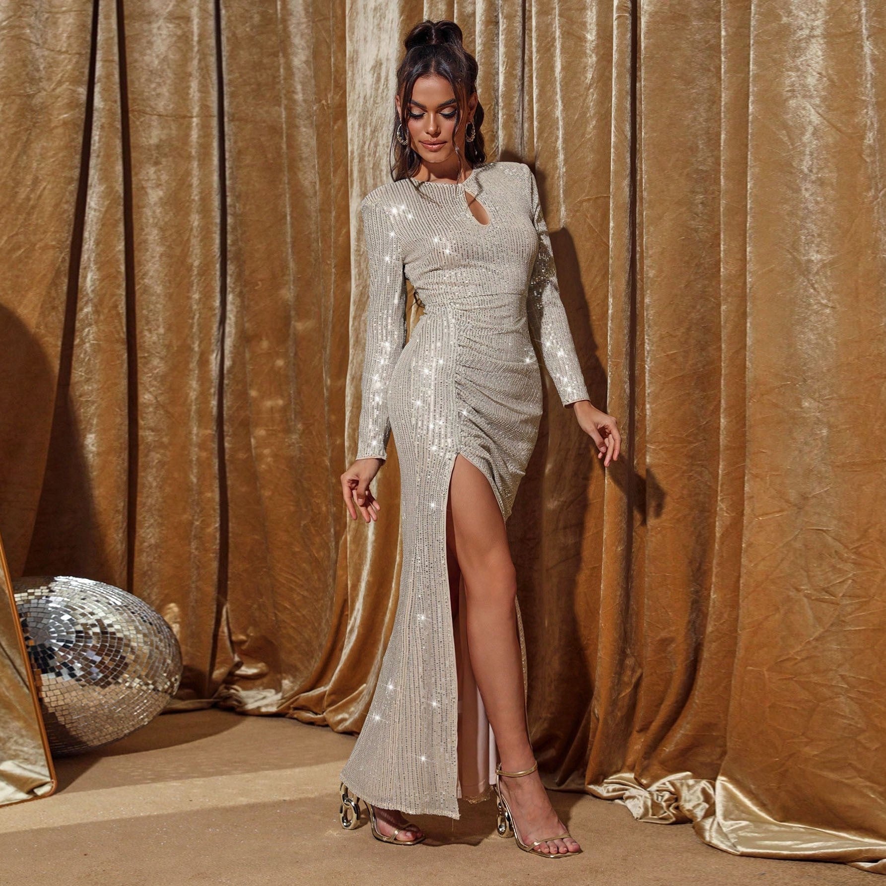 Side profile of the apricot sequined dress highlighting the flattering high-waisted cut and high slit for a chic, silhouette-enhancing fit