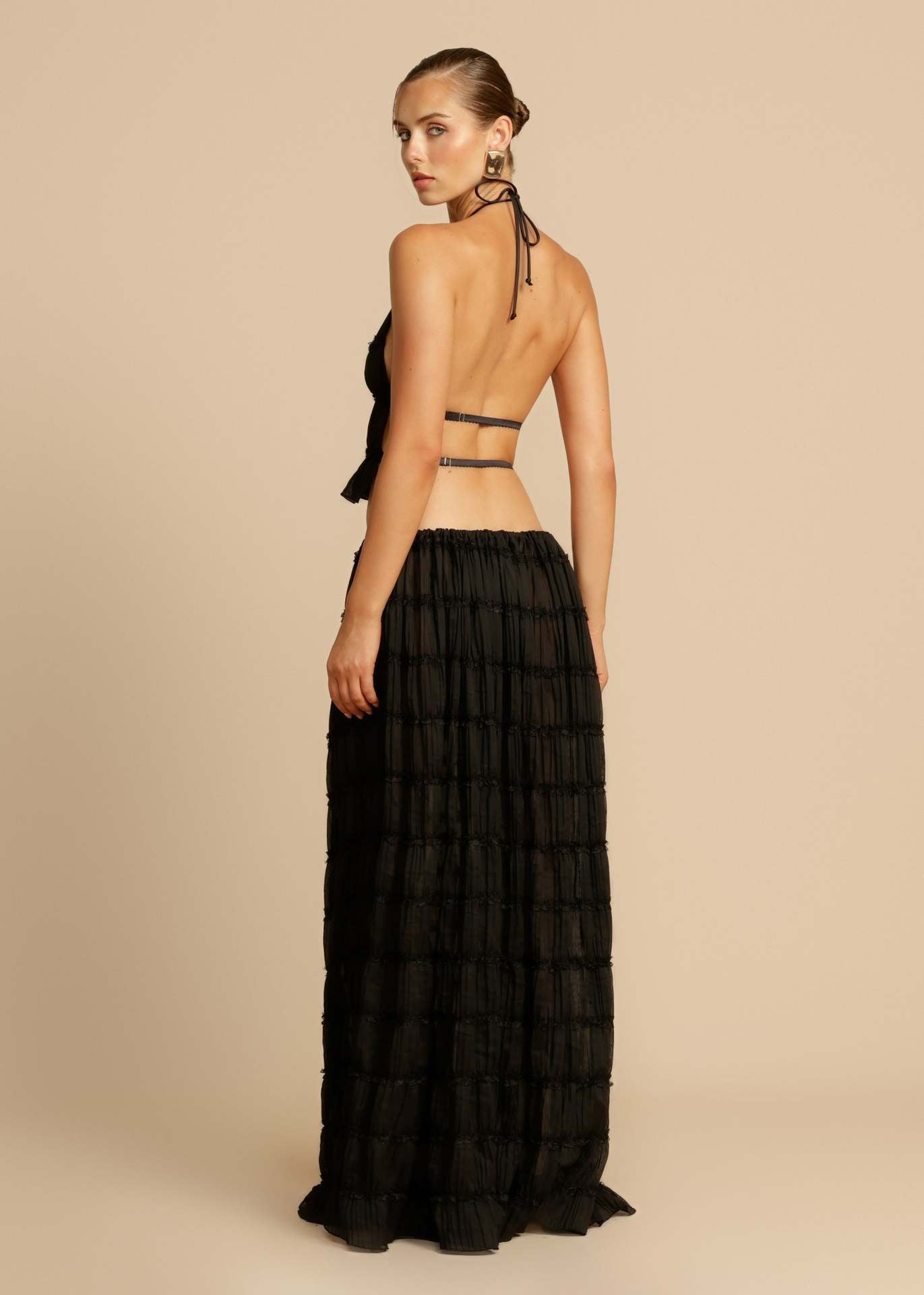 Back view of the Black Chiffon Backless Lace-up Pleated Maxi Dress, featuring the adjustable lace-up design and open back.