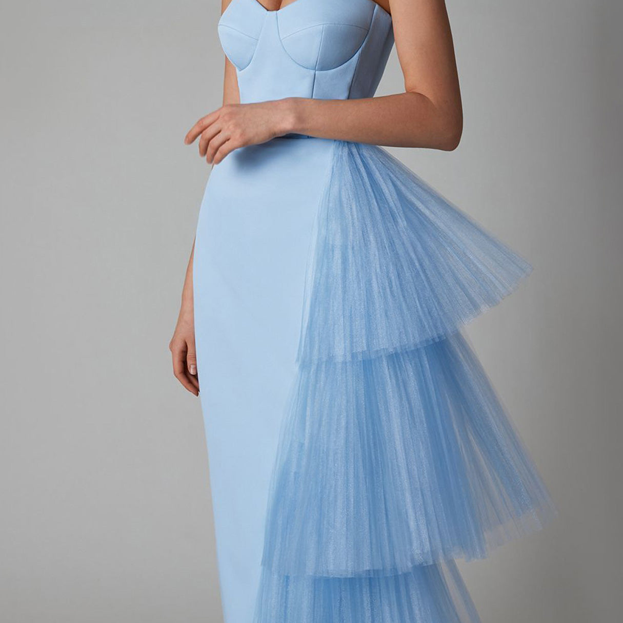 Close-up detail view of the pleated mesh splicing and stretch fabric of the blue sleeveless maxi dress, emphasizing the texture and quality.