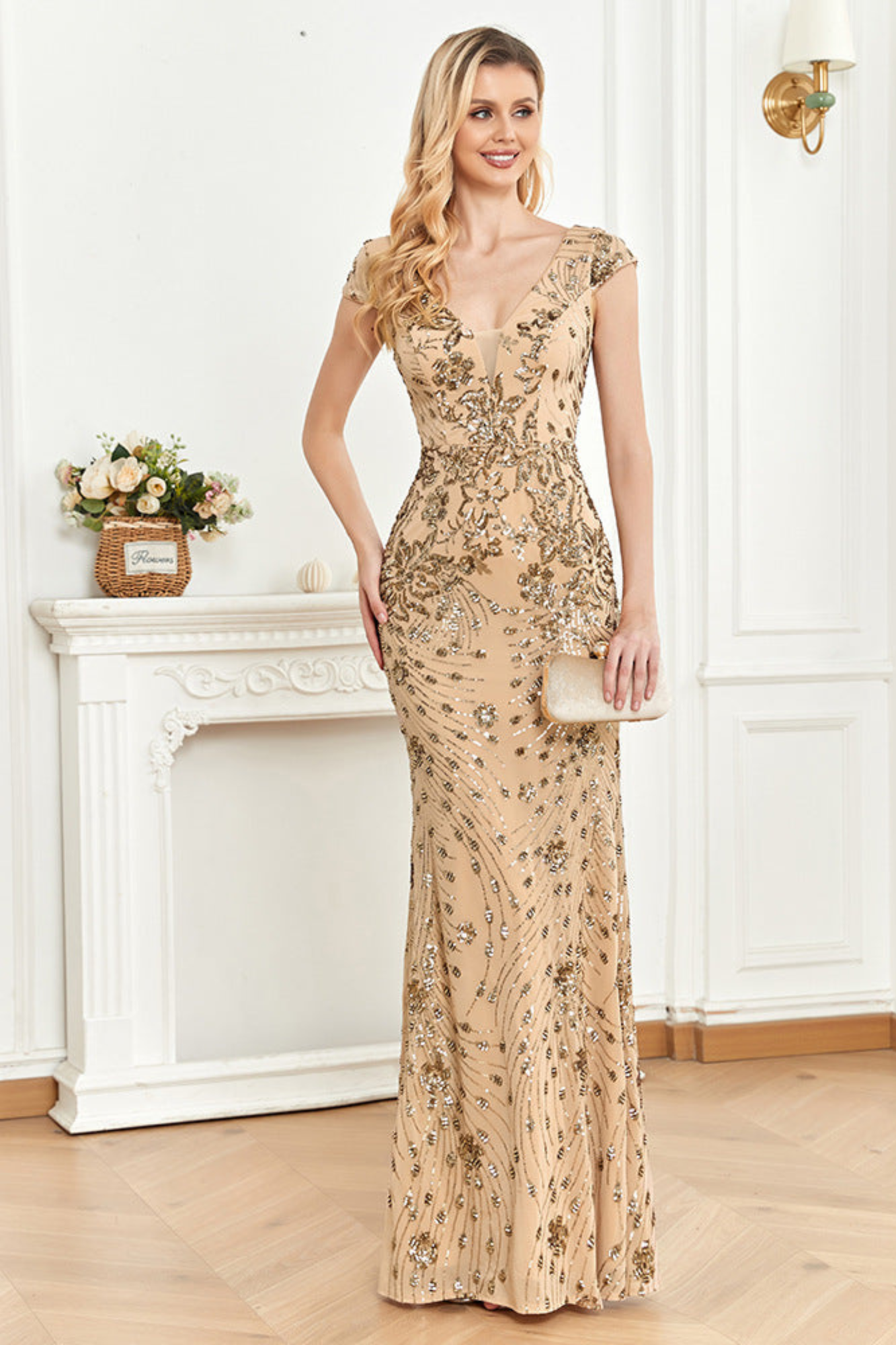 Front view of an elegant champagne mermaid dress featuring a V-neck, sleeveless design, and sparkling sequin embellishments.