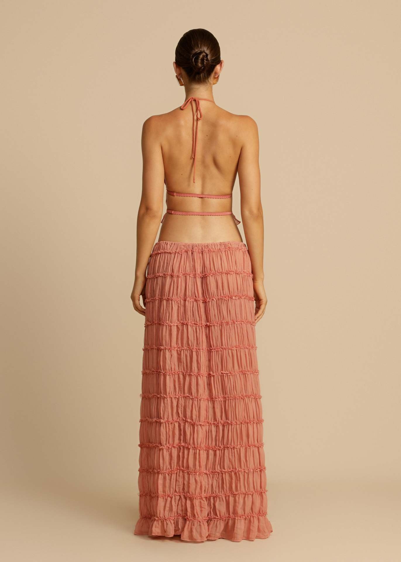 Back view of the Pink Chiffon Backless Lace-up Pleated Maxi Dress, featuring the adjustable lace-up design and open back.