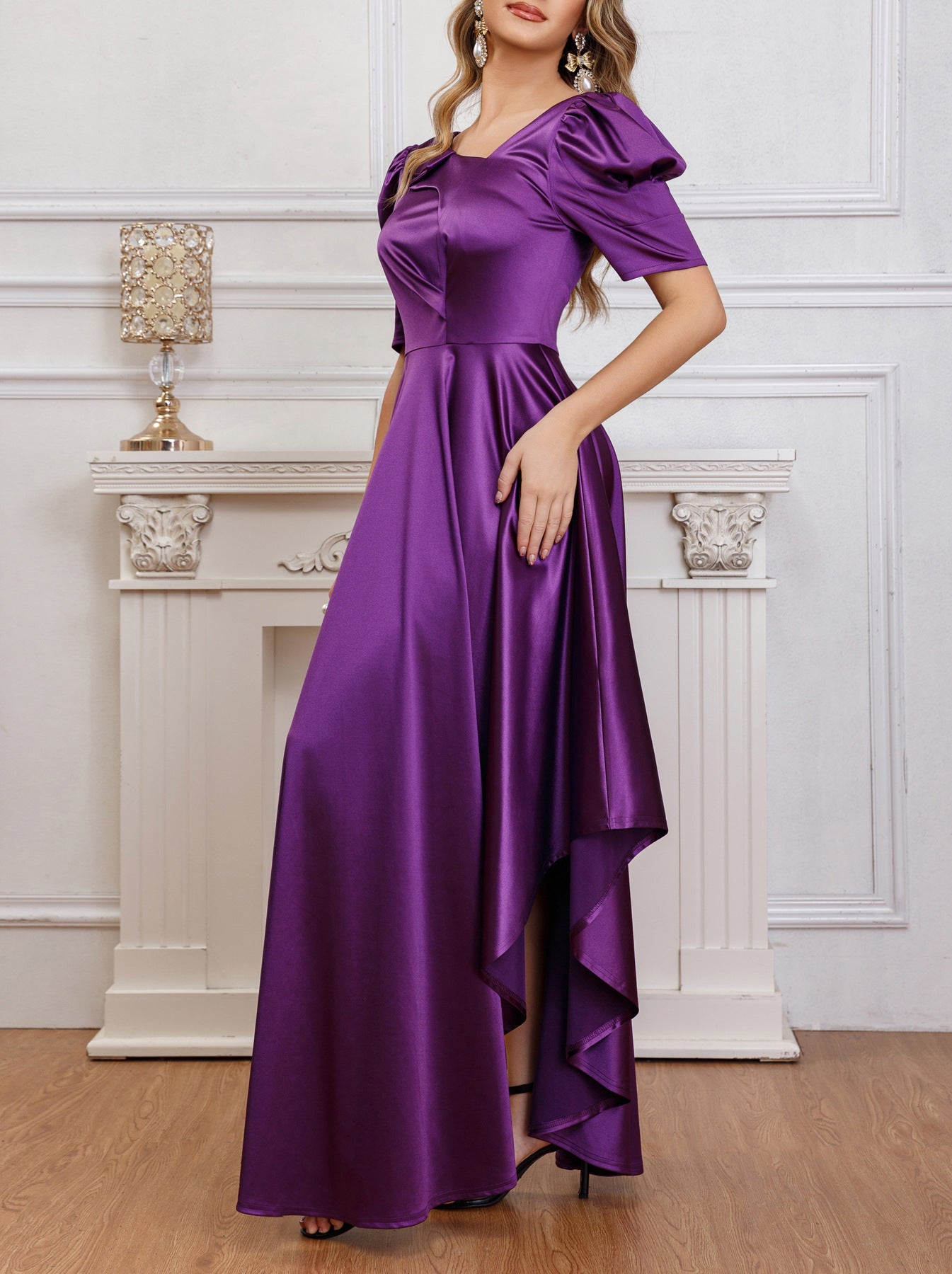 Side view of a purple puff sleeve satin pleated dress showcasing the flowing irregular hem and smooth satin fabric.