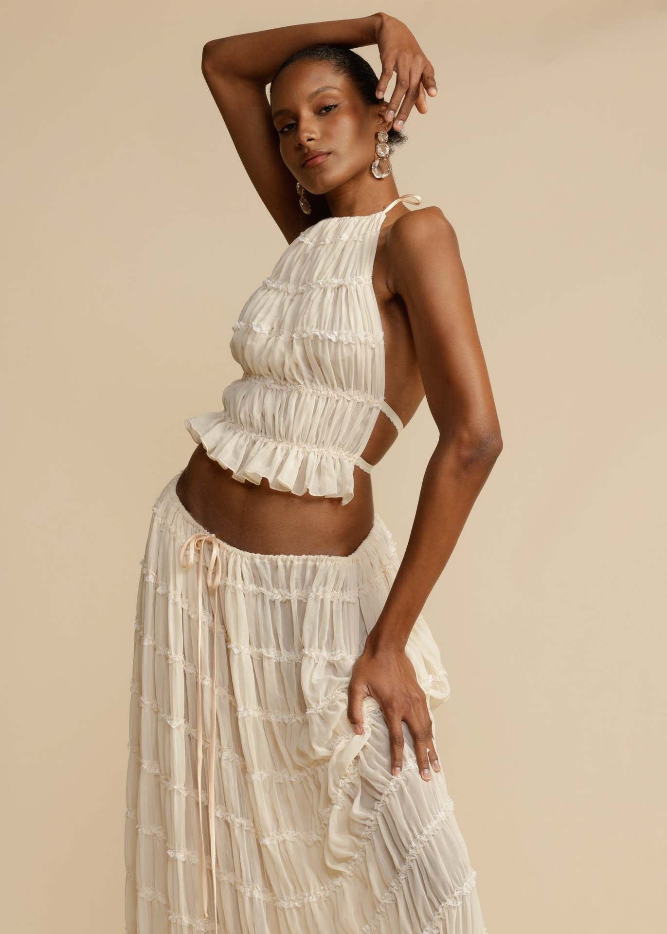 Close-up of the pleated chiffon fabric and lace-up back of the White Chiffon Backless Lace-up Pleated Maxi Dress, showcasing the intricate details and premium quality.