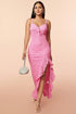 A woman is wearing a pink lace dress with a sleeveless and backless design. The dress features intricate embroidery on the lace fabric, and the adjustable suspenders provide a relaxed yet stylish fit. The front view highlights the flattering cut and the delicate lace texture, perfect for outdoor events or casual leisure activities.
