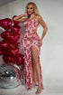 Side view of a pink sleeveless floral printed pleated suspender maxi dress showcasing its elegant high slit and flattering pleated silhouette.