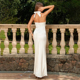 Back view of the White Sleeveless Hanging Neck Show Waist Satin Maxi Dress, featuring a bold backless design and hanging neck detail.
