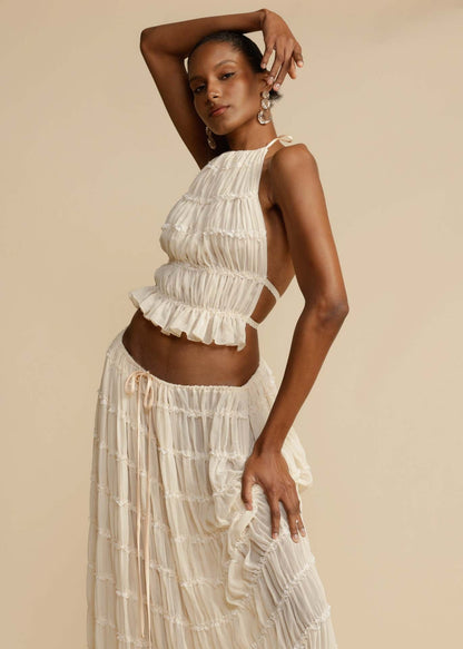 Close-up of the pleated chiffon fabric and lace-up back of the White Chiffon Backless Lace-up Pleated Maxi Dress, showcasing the intricate details and premium quality.