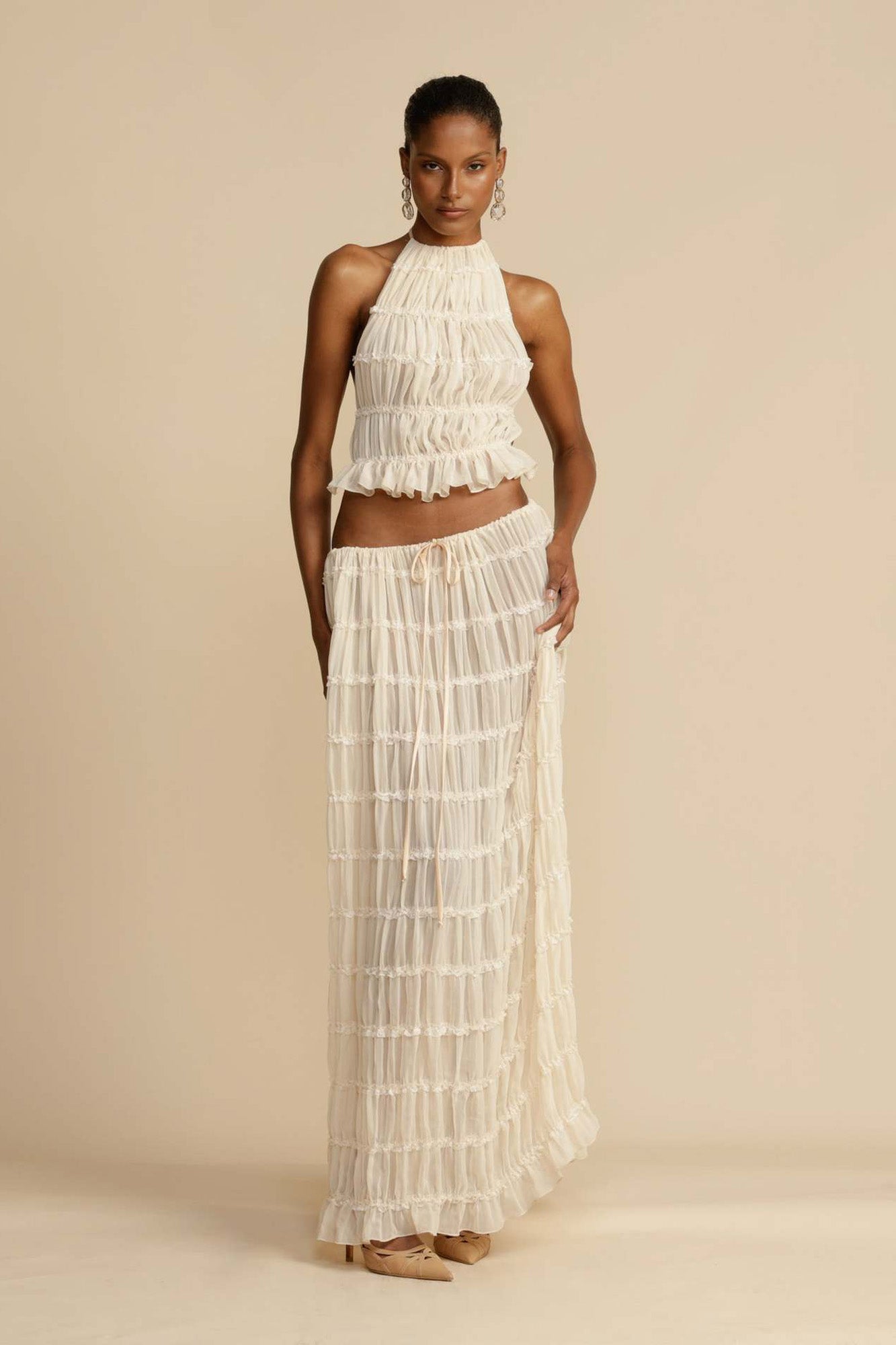 Front view of the White Chiffon Backless Lace-up Pleated Maxi Dress, showcasing the elegant pleated design and hanging neck style.